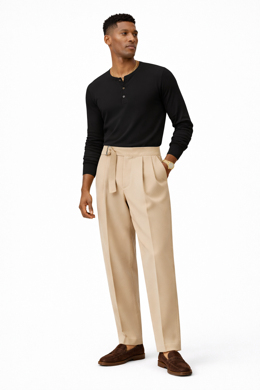Man wearing a black henley shirt and beige pants on a white background